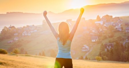 Frau im Sonnenaufgang als Symbol für neue Kraft, Immunsystem und Lebensfreude